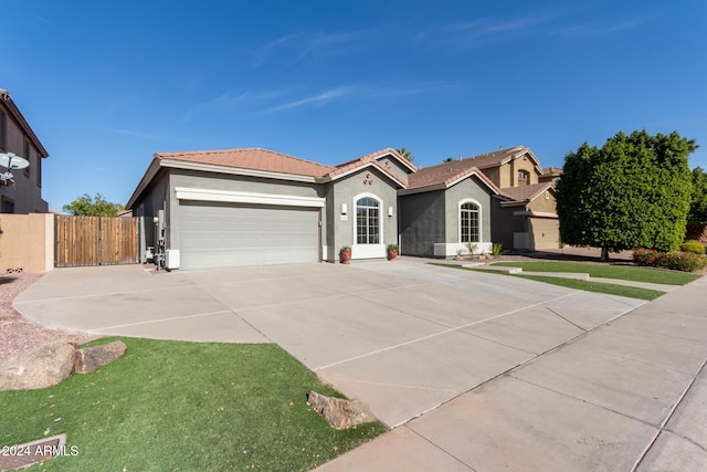 view of front facade with a garage and a front lawn