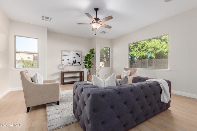 living room with light wood-type flooring and ceiling fan