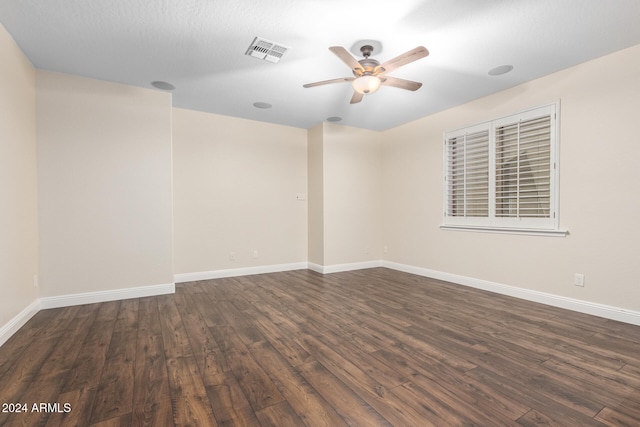 spare room featuring ceiling fan, dark hardwood / wood-style floors, and a textured ceiling