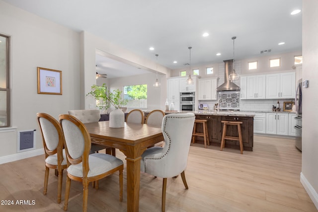 dining space featuring light hardwood / wood-style flooring and ceiling fan