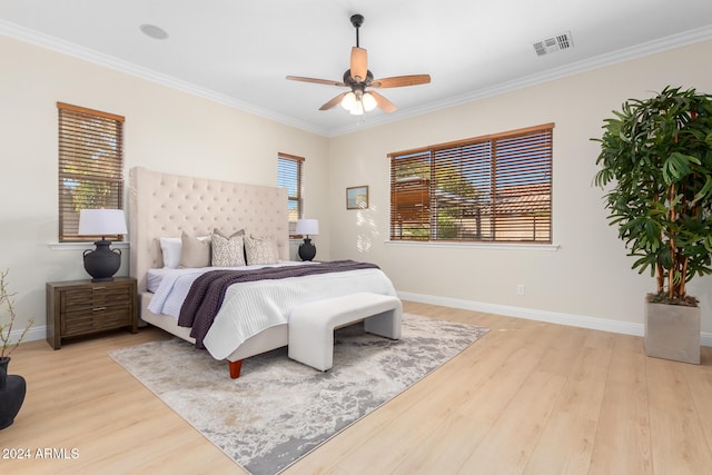 bedroom with ceiling fan, light hardwood / wood-style floors, and crown molding