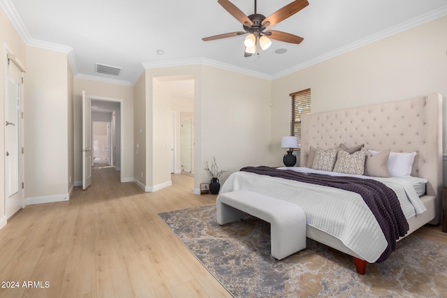 bedroom featuring light hardwood / wood-style floors, ceiling fan, ensuite bath, and ornamental molding