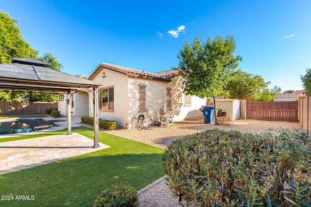 view of yard featuring a patio, a pool, and a gazebo