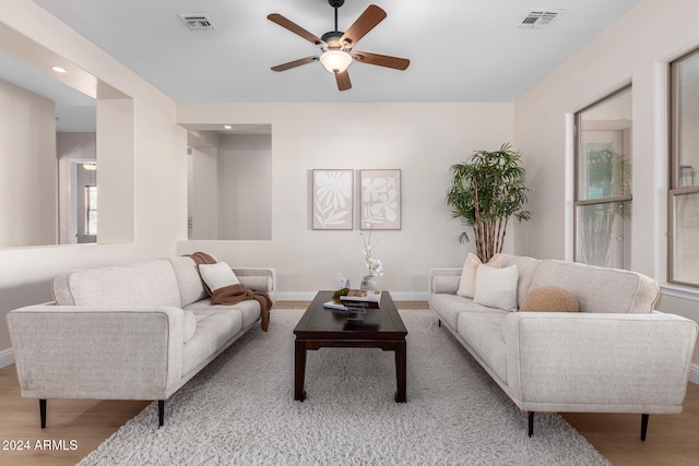 living room with light wood-type flooring and ceiling fan