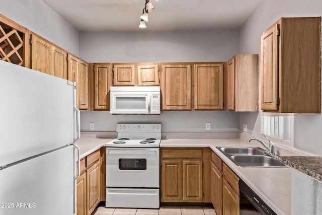 2929 W Yorkshire Dr Unit 2074, Phoenix, AZ 85027 - kitchen with white appliances, a sink, rail lighting, light tile patterned floors, and light countertops