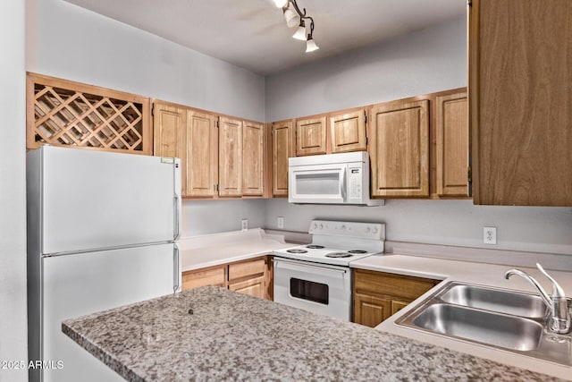 2929 W Yorkshire Dr Unit 2074, Phoenix, AZ 85027 - kitchen with white appliances, a sink, rail lighting, light countertops, and a peninsula