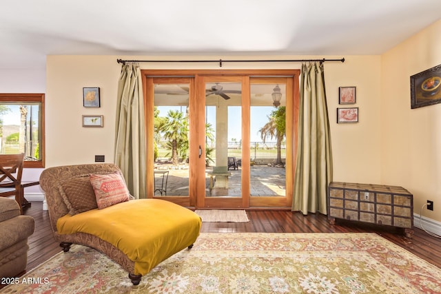 entryway featuring a ceiling fan, baseboards, a wealth of natural light, and hardwood / wood-style flooring