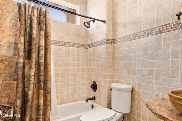 bathroom featuring shower / tub combo with curtain, toilet, and tile walls