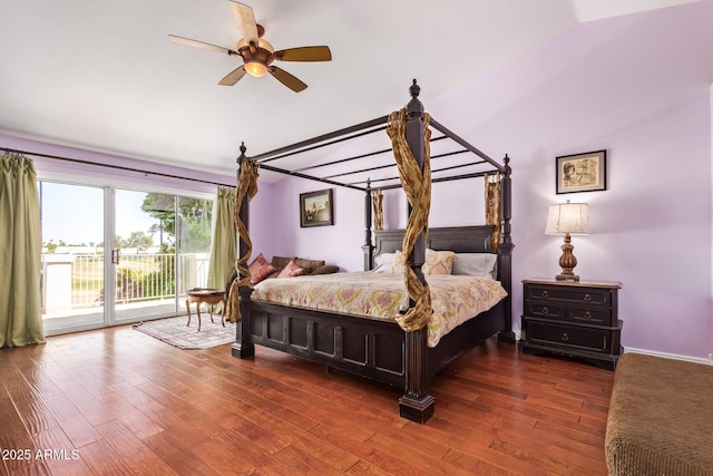 bedroom featuring wood finished floors, ceiling fan, lofted ceiling, and access to exterior
