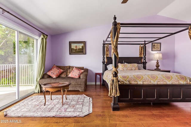bedroom featuring a ceiling fan, access to exterior, wood finished floors, and lofted ceiling