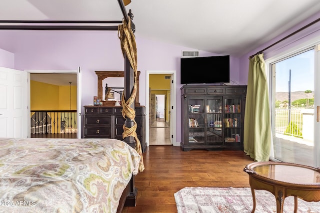 bedroom featuring visible vents, access to exterior, lofted ceiling, and wood finished floors