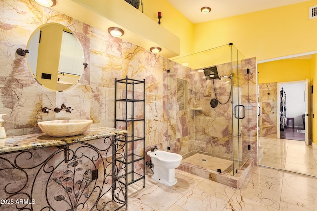 bathroom with a bidet, visible vents, a stall shower, a sink, and marble finish floor