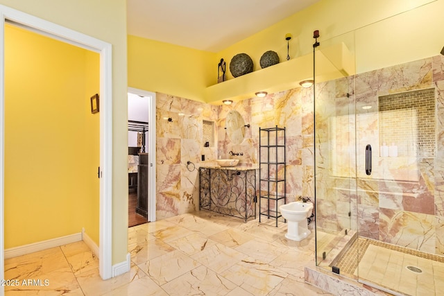 full bath featuring vanity, marble finish floor, a bidet, and a stall shower