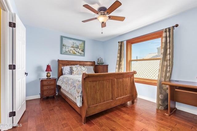 bedroom with baseboards, ceiling fan, and wood finished floors