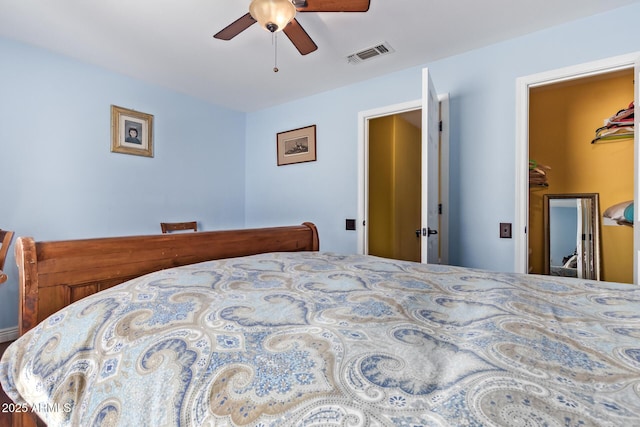 bedroom featuring a ceiling fan and visible vents