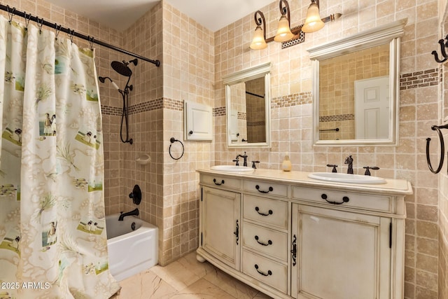 full bathroom featuring double vanity, tile walls, shower / bath combination with curtain, and a sink