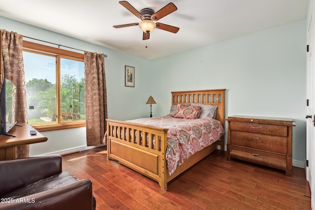 bedroom with baseboards, a ceiling fan, and wood finished floors