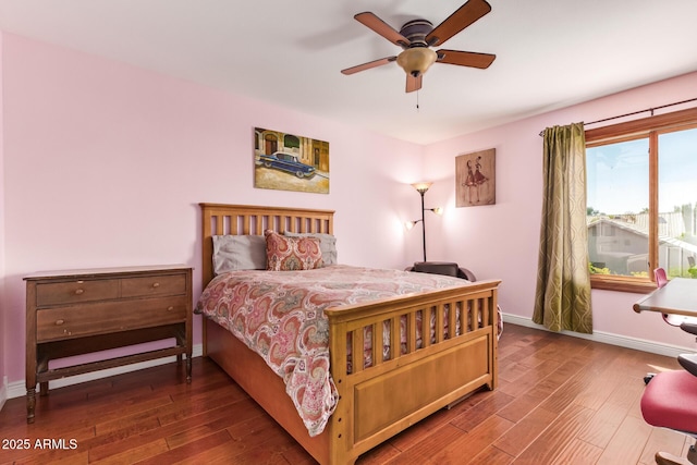 bedroom with baseboards, ceiling fan, and wood finished floors