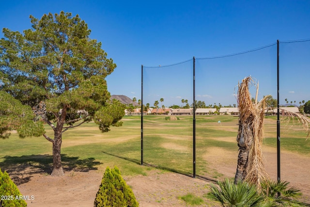 view of property's community with a lawn and view of golf course