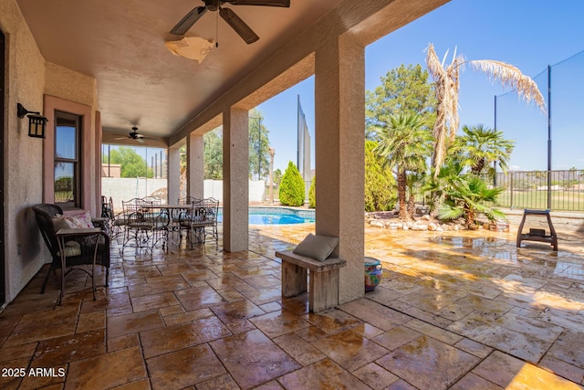 view of patio with a fenced backyard, a fenced in pool, ceiling fan, and outdoor dining space