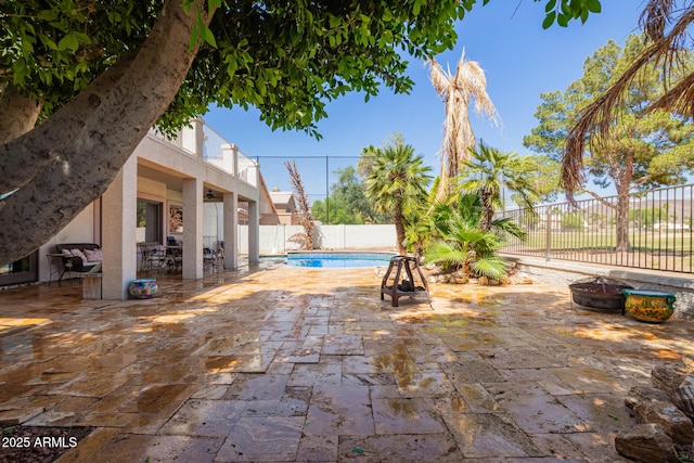 view of pool featuring a fenced in pool, a fenced backyard, a patio area, and an outdoor fire pit