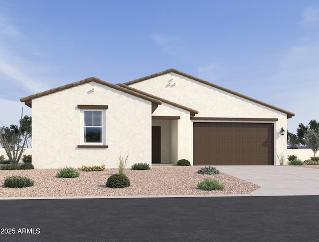 view of front of property featuring a garage, concrete driveway, and stucco siding