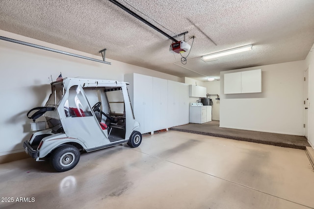 garage with washer and dryer, a garage door opener, and baseboards