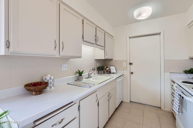 kitchen featuring white appliances, white cabinets, light countertops, light tile patterned floors, and decorative backsplash