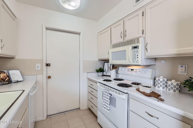 kitchen featuring light tile patterned floors, white cabinets, white appliances, and light countertops