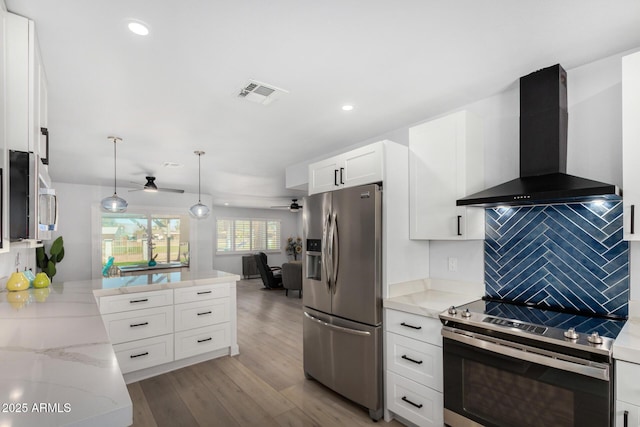 855 S Revolta Cir, Mesa, AZ 85208 - kitchen featuring ceiling fan, visible vents, a peninsula, wall chimney exhaust hood, and stainless steel appliances
