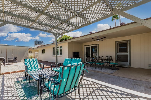 855 S Revolta Cir, Mesa, AZ 85208 - view of patio / terrace featuring a ceiling fan, a storage unit, a pergola, outdoor dining area, and an outbuilding
