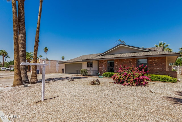 855 S Revolta Cir, Mesa, AZ 85208 - view of front of house with roof with shingles, an attached garage, brick siding, and driveway