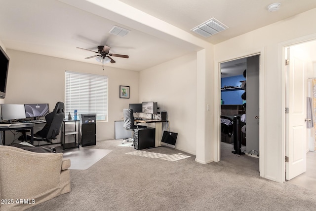 carpeted office space with ceiling fan