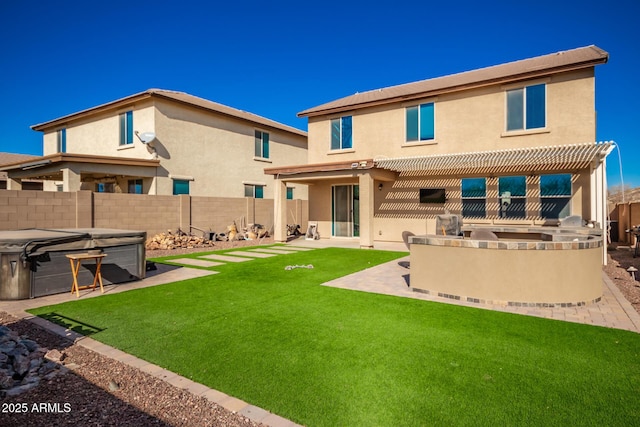 back of property with a hot tub, a lawn, a patio area, and a pergola