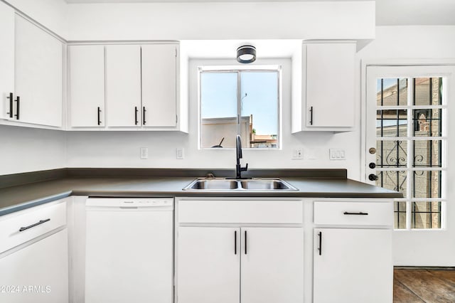 kitchen with white cabinets, sink, and white dishwasher