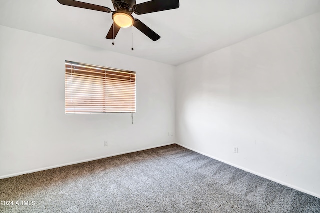 spare room featuring ceiling fan and carpet floors