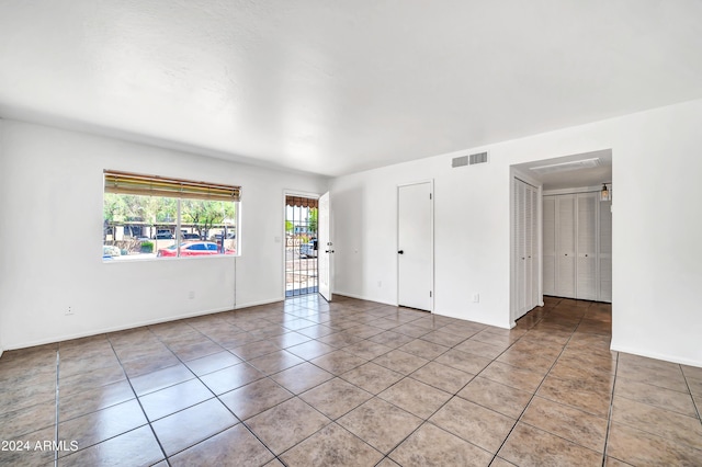 unfurnished room featuring tile patterned floors