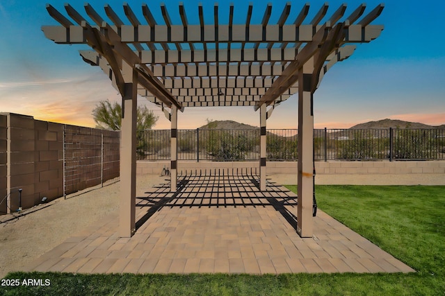 view of patio / terrace featuring a mountain view, a fenced backyard, and a pergola