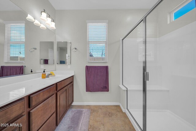 full bathroom with a stall shower, baseboards, vanity, and a chandelier