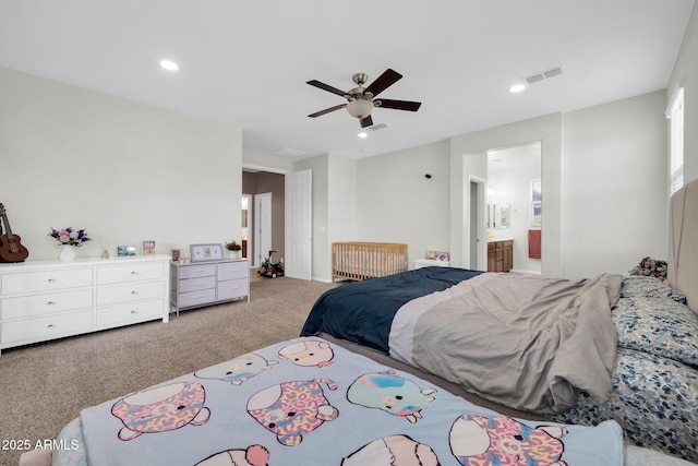 carpeted bedroom with ensuite bathroom, visible vents, recessed lighting, and a ceiling fan