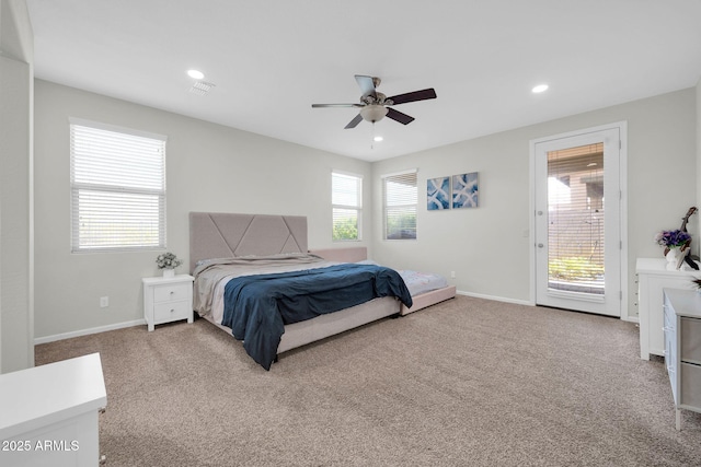 bedroom with multiple windows, access to exterior, and carpet flooring