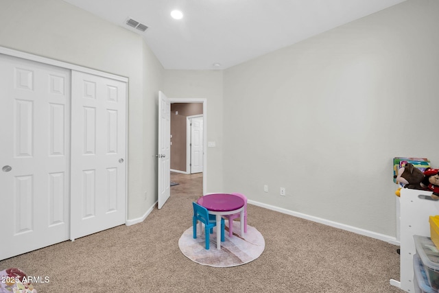 game room featuring baseboards, visible vents, and carpet