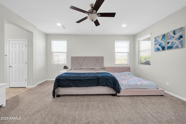 bedroom with multiple windows, carpet floors, and baseboards