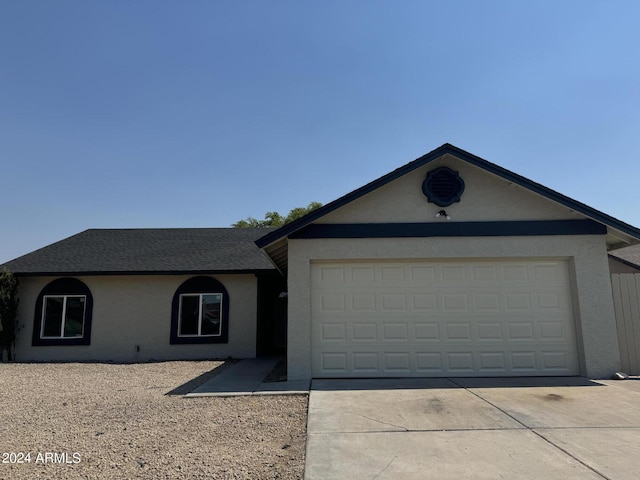 single story home featuring a garage