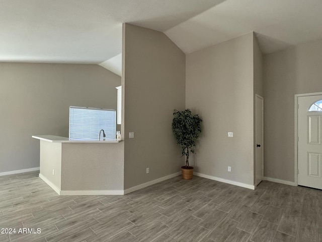 foyer featuring lofted ceiling