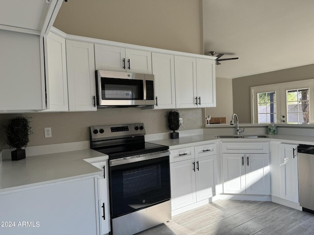 kitchen with white cabinets, french doors, stainless steel appliances, and sink