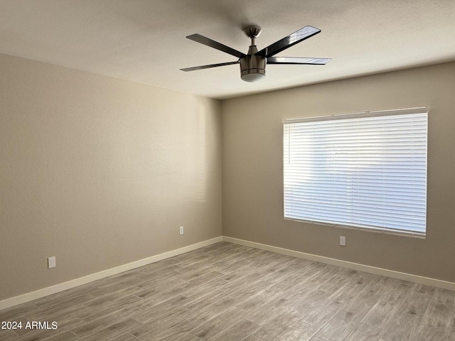 empty room featuring light hardwood / wood-style flooring and ceiling fan