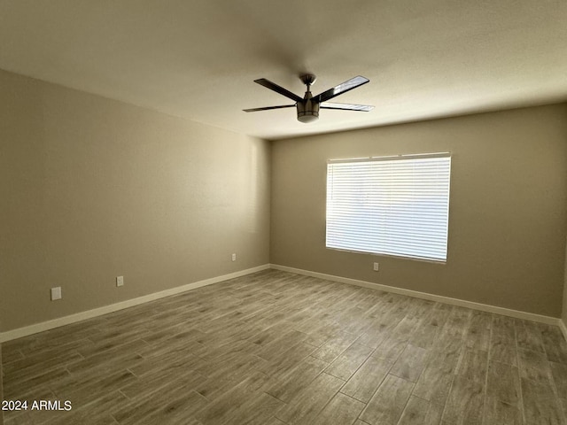 unfurnished room featuring ceiling fan and hardwood / wood-style floors