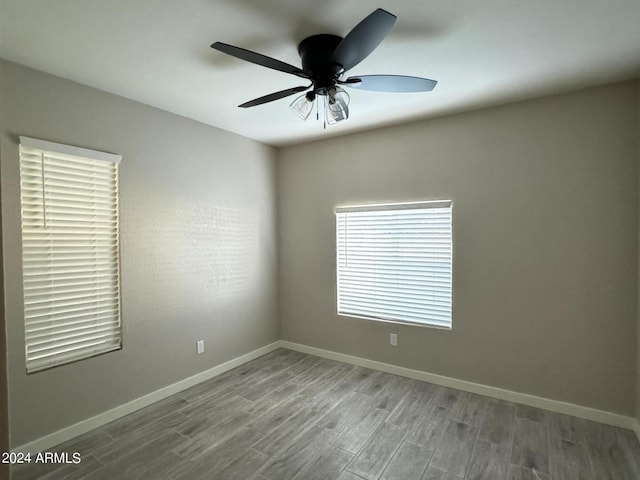 spare room featuring light wood-type flooring and ceiling fan