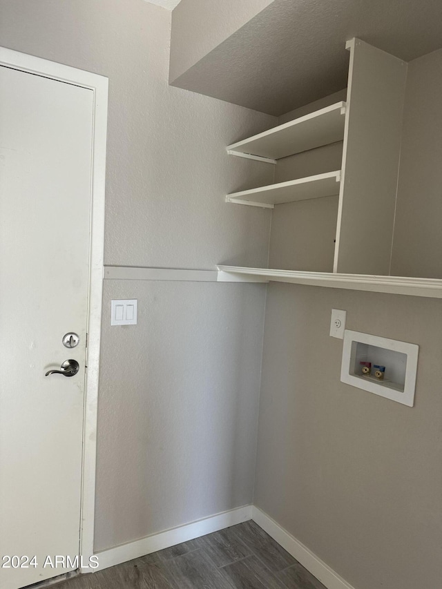 laundry room with washer hookup and dark wood-type flooring